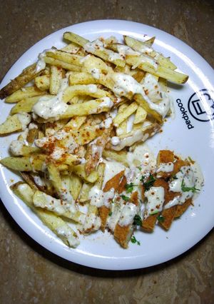 A picture of Cheesy Chicken fries with yogurt herb Sauce.