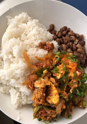 A picture of Egg sauce with rice and beans.