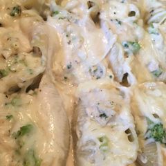 A picture of Stuffed shells with chicken and broccoli.