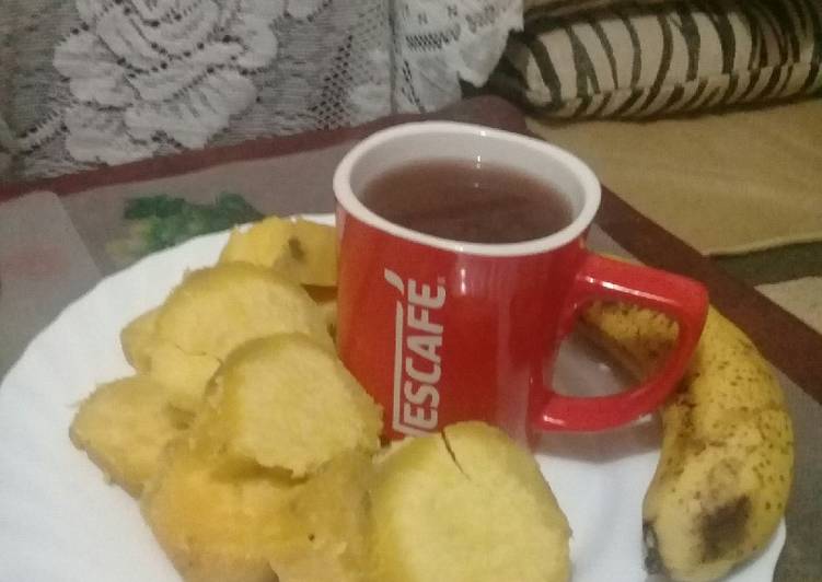 Boiled sweet potatoes, banana n a cup of hot Nescafe