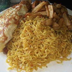 A picture of Indomie, chips and fried egg.