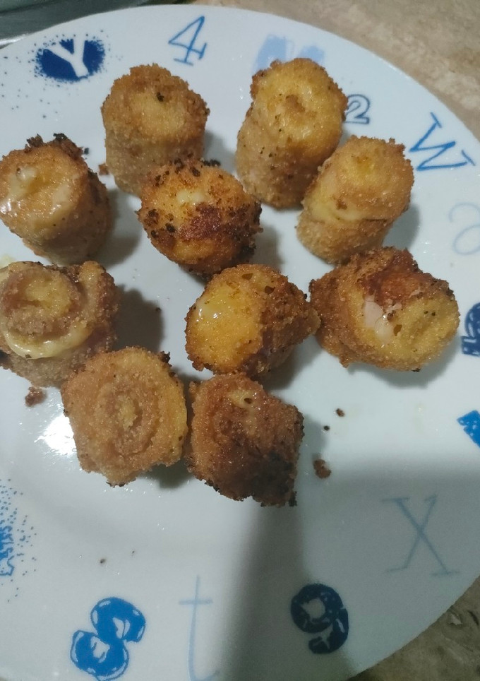 Una foto de Canapé mini rollitos de bacon y queso