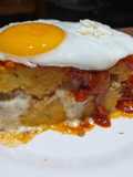 Pastel de polenta con bolognesa, queso, tuco y a caballo