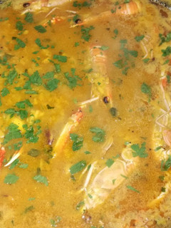 Una foto de Arroz caldoso con calamares y cigalas