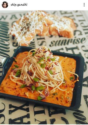 A picture of Garlic burnt Spaghetti with red sauce.