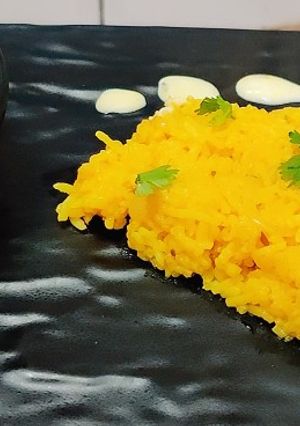 A picture of Onion rice with tadka raita.
