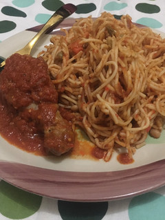A picture of Daisy’s Christmas treats - Spaghetti jollof and stewed Chicken.