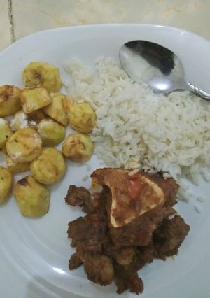 A picture of Stewed Beef, deep fried potatoes served with boiled rice.