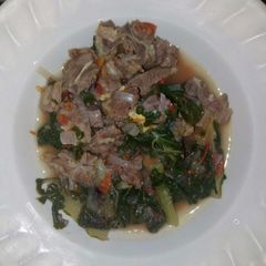 A picture of Boiled goat and spinach.