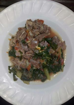 A picture of Boiled goat and spinach.