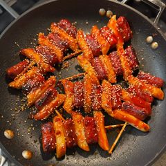 A picture of Tteok kochi (sticky rice cake and sausage skewers).