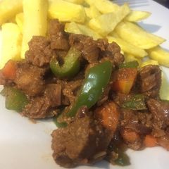 A picture of Stir n fry Beef served with fries.