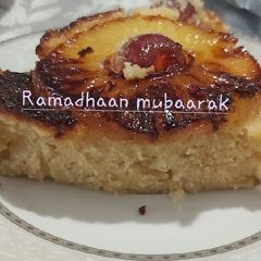 A picture of Pineapple and candy cherry slices.