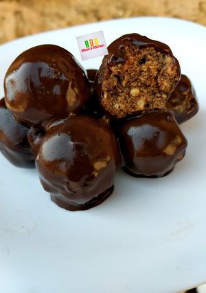 A picture of Tiramisu Truffles in chocolate sauce.