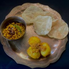 A picture of Durga Ashtami Platter - Luchi, Aloo Dum, Chola’r Dal.