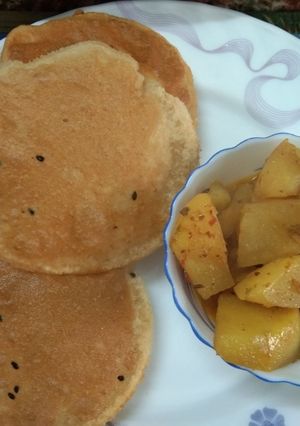 A picture of Aloo Curry with Onion Seeds poori.