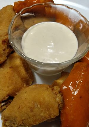 A picture of Crunchy pan-fried chicken wings with blue cheese dip.