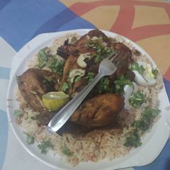 A picture of Mughalai egg stuffed murg mussallam platter.