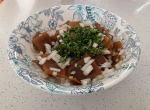 Una foto de Cochayuyo en ensalada con cebolla blanca y cilantro