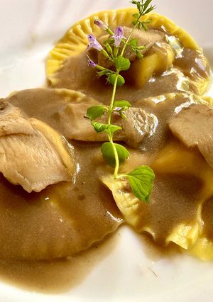 A picture of Ravioli with Pumpkin Pasta and Ricotta Filling in Porcini Mushroom Béchamel.