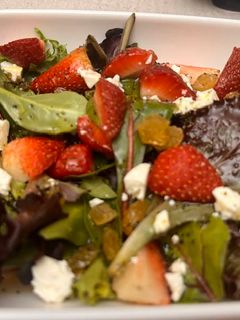A picture of Mixed green strawberry salad.