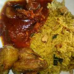A picture of Egg and shredded chicken rice with sauce and fried chicken.