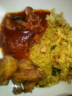 A picture of Egg and shredded chicken rice with sauce and fried chicken.