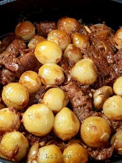 A picture of Beef Stifado in a Dutch Oven.