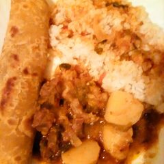 Beef stew served with chapati and rice A picture of Beef stew served with chapati and rice.