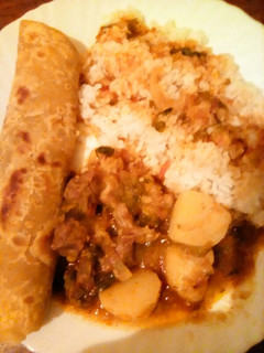A picture of Beef stew served with chapati and rice.