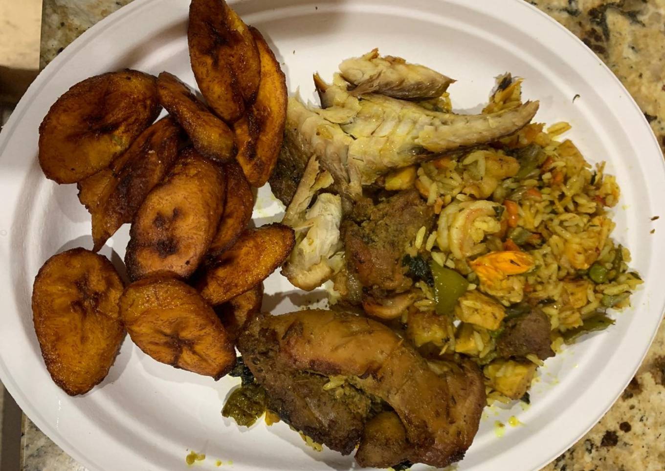 Jollof rice with fried plantain,fried chicken and smoked fish