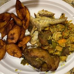 Jollof rice with fried plantain,fried chicken and smoked fish A picture of Jollof rice with fried plantain,fried chicken and smoked fish.