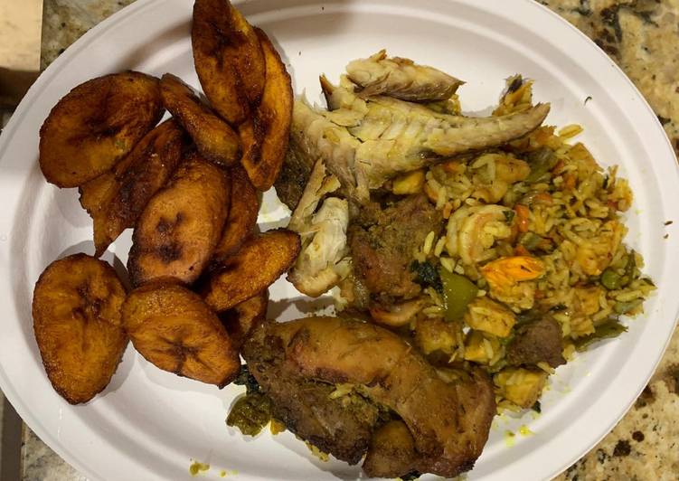 Jollof rice with fried plantain,fried chicken and smoked fish