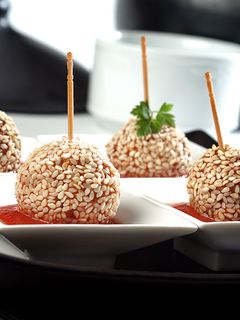 A picture of Chicken lollipops with tomato sauce.