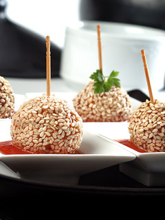 A picture of Chicken lollipops with tomato sauce.