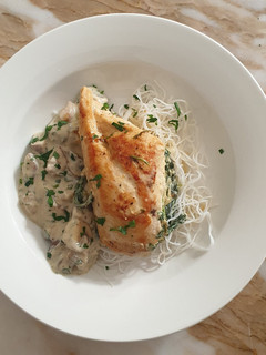 A picture of Stuffed chicken with mushroom sauce.