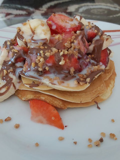 Una foto de Pancakes con fresas y plátano