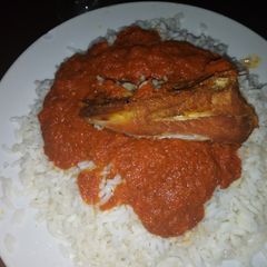 A picture of Coconut rice with chicken stew.