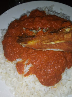 A picture of Coconut rice with chicken stew.