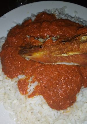A picture of Coconut rice with chicken stew.