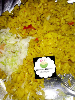 A picture of Curry jollof rice with coslow.
