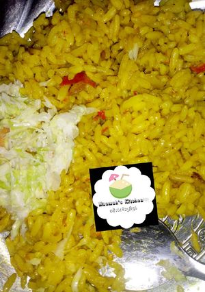 A picture of Curry jollof rice with coslow.