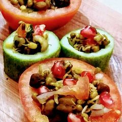 A picture of Mixed sprouts in cucumber and tomato cups.