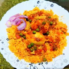A picture of Egg curry with green pea.