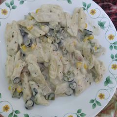 A picture of White pasta with black olive.