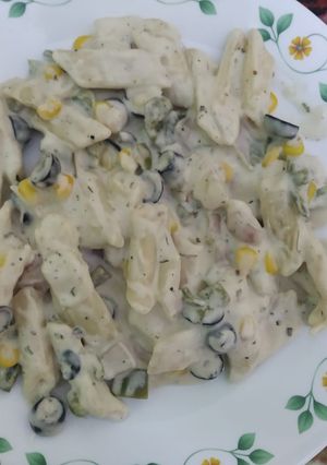 A picture of White pasta with black olive.