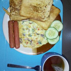 A picture of Cripsy toast, eggs and sausage.