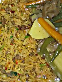 A picture of Minced meat mandy rice with potato soup.