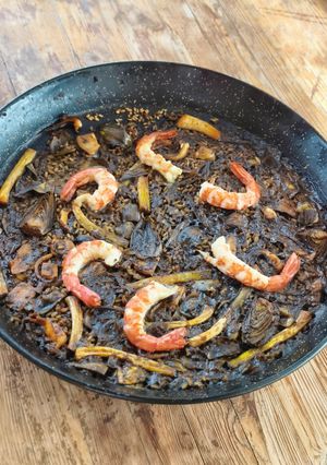 A picture of Black Rice with Cuttlefish, Artichokes, Shrimp, and Green Garlic.