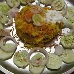 A picture of Chatpate rice with curd aloo bhujia and salad.